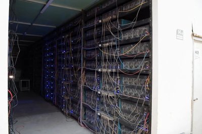 GreenHash Mining farm implementing immersion cooling technology to reduce energy consumption.