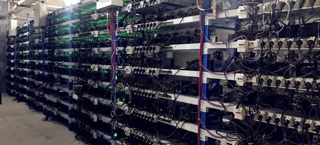 A close-up of a powerful mining rig, showcasing its intricate cooling system and multiple GPUs.